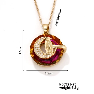 Detailed view of golden moon pendant with purple crystals and central relief carving