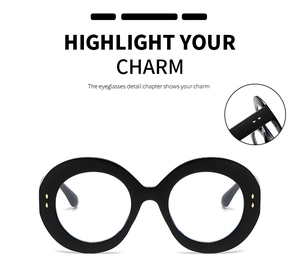 Detailed view of black oversized round glasses frames with gold rivets and sturdy hinges