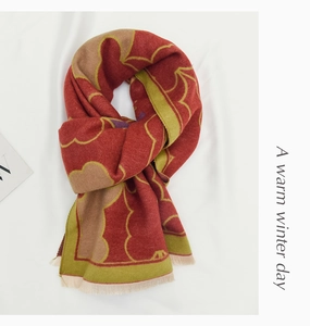Detail of red and green patterned winter scarf with soft fringe edges for kids