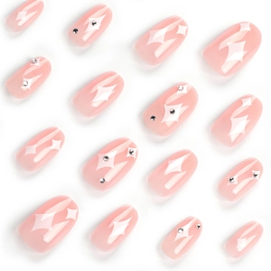 Minimalist jelly pink press-on nails with white star patterns and tiny rhinestones