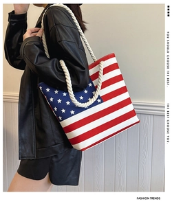 Fashionable canvas tote bag with American flag pattern and thick rope handles on model