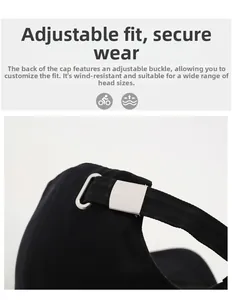 Detail of black cotton baseball cap showing adjustable silver metal buckle and strap