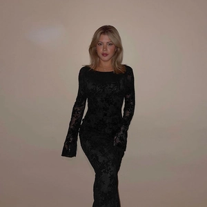 Detailed close-up of long sleeve black floral lace texture on a slim fit maxi dress
