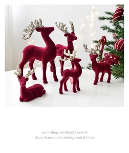 Macro detail of wine red flocked reindeer ornaments with sparkling gold antlers