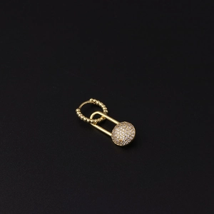 Macro detail of gold safety pin drop earring with micro-paved cubic zirconia sphere