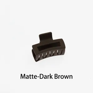 Detail view of a 4cm mini dark brown matte hair claw clip with a hollow square design