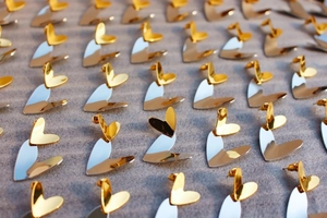 Detailed grid layout of mirror-polished gold and silver contrasting heart stud earrings