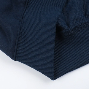 Detailed macro view of the ribbed knit cuffs on a navy blue casual cotton sweatshirt