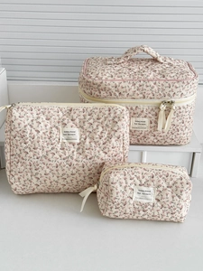 Three-piece floral corduroy cosmetic bag set featuring pink flower patterns on cream base