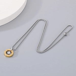 Detail shot of hexagonal two-tone necklace pendant with octagonal star in gold and silver