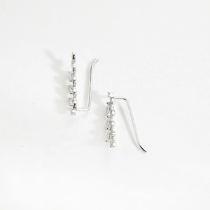 Detailed macro shot of S925 sterling silver ear crawlers with sparkling zircon leaves