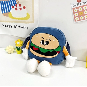 Detail of a cartoon burger messenger bag with plush 3D limbs and adjustable blue strap
