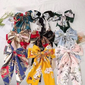 Satin bow hair clip with floral print and long streamers in various colors