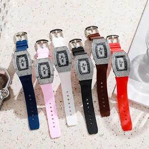 Close-up of luxury tonneau-shaped women's quartz watches with sparkling rhinestone bezels