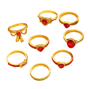 8-piece set of vintage gold rings with red heart gemstones and bow designs