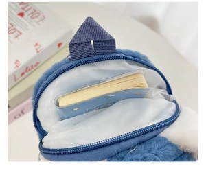 Detail of blue plush cartoon bag interior with zipper and soft fabric texture