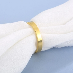 Macro detail of 3mm gold-plated stainless steel ring nestled in soft white fabric