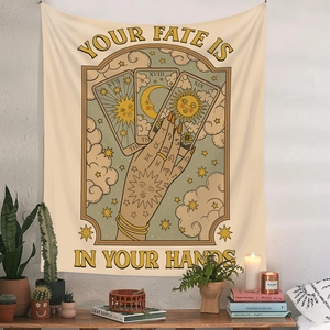 Detail of tarot tapestry with 'Your Fate is in Your Hands' text and sun moon stars icons