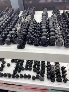Macro view of matte black obsidian puppy figurines neatly arranged on shelves