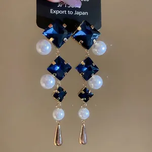 French palace style rhodium drop earrings with blue crystals and elegant pearls