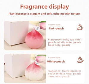 Close-up of pink and white peach shaped scented candles with fruit aroma and packaging