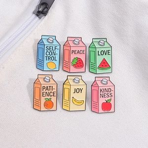 Set of six fruit juice box enamel pins with inspirational words on white canvas