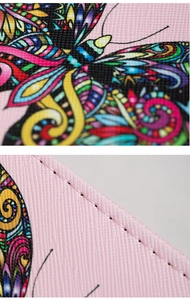 Detailed close-up of pink butterfly embossed PU leather with cross-grain texture and stitching