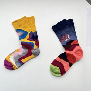 Artistic mid-calf cotton socks featuring colorful abstract patterns and mountain landscapes