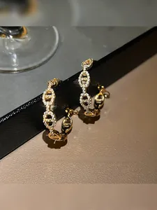 Detailed view of gold pig nose earrings with sparkling pavé cubic zirconia inlay