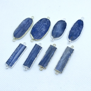Detail of natural kyanite connectors with gold and silver plated metal frames