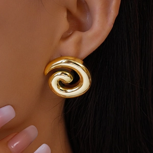 Detailed view of glossy golden spiral stud earring featuring a polished swirl design