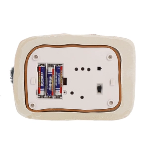 Macro detail of the bottom battery compartment and power switch of a Christmas snow house