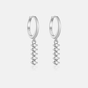 Macro shot of S925 sterling silver hoop earrings with five dangling white cubic zirconia