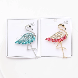 Detail of pink and blue crystal flamingo brooches on fashion jewelry display cards