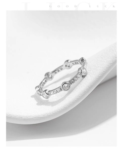 Macro shot of silver geometric ring with pavé-set clear cubic zirconia accents