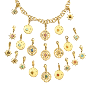 Macro view of French vintage gold necklace with detachable gemstone sun pendants