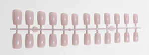 Macro view of glossy pink long square press-on nails on professional layout carrier