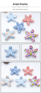 Macro shot of star-shaped PVC hair claws with smiley and starfish patterns in various colors
