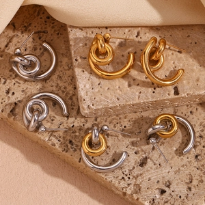Three pairs of twisted C-shaped stainless steel earrings in gold, silver and two-tone finish