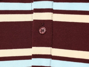 Detail of three-color striped polo collar with four-hole button and knit texture