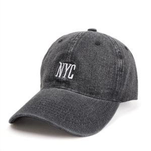 Vintage dark grey washed denim baseball cap with white NYC embroidery in a side view