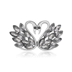 Close-up of heart-shaped twin swan brooch with sparkling black crystals and silver finish