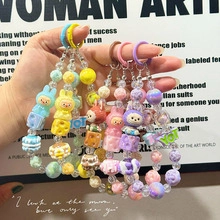 Detail of colorful macaron beaded keychains with cute cartoon rabbit and bear pendants