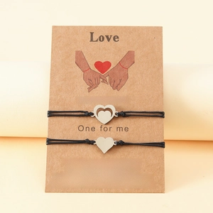 Close-up of mother and daughter butterfly bracelets with love message on card