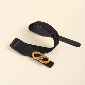 Detail view of the black elastic waist belt featuring a gold double ring metal buckle closure