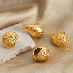 Golden titanium steel earrings set with irregular textured round and pear drop shapes