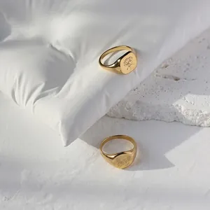 Vintage 18K gold-plated signet rings featuring engraved floral and butterfly patterns