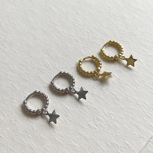 Detail view of minimalist S925 sterling silver beaded hoop earrings with star charms