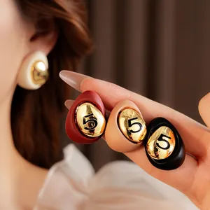 Retro gold-plated oval stud earrings with black number 5 relief for an elegant look