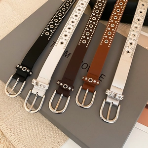 Detail view showing five colors of leather rivet belts with rhinestones and oval buckles